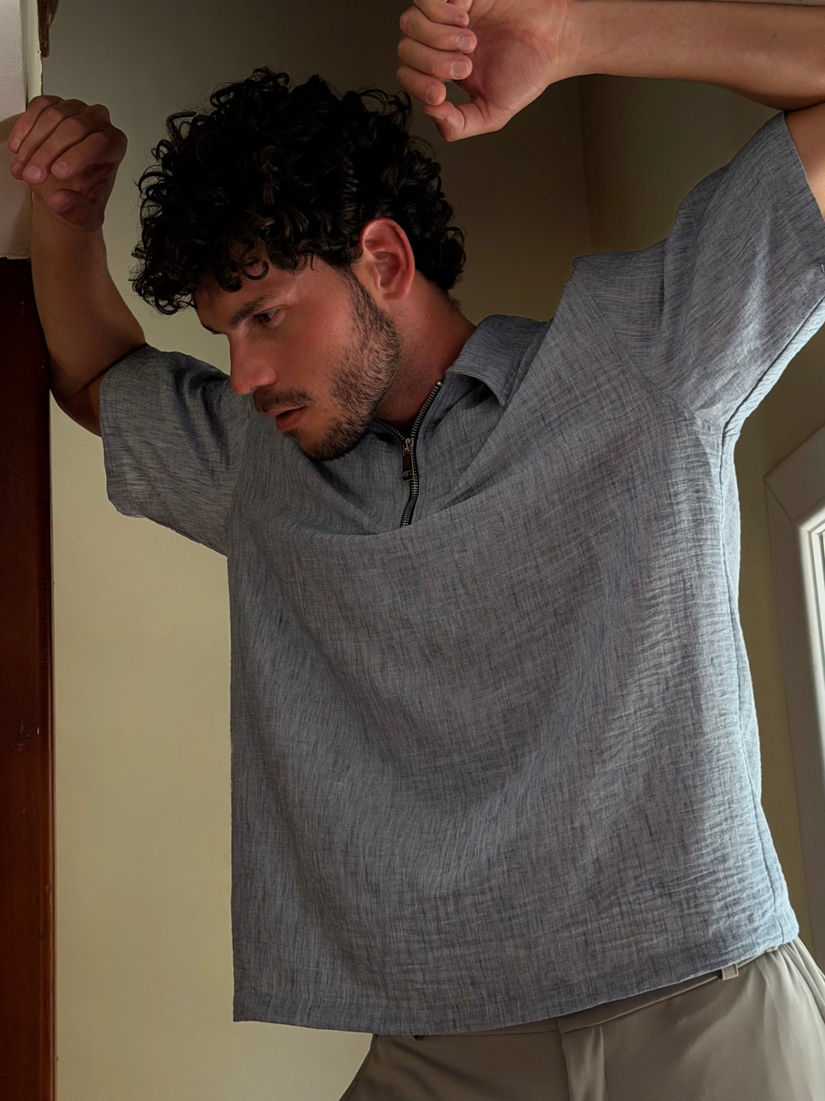 Man in the light blue zip polo